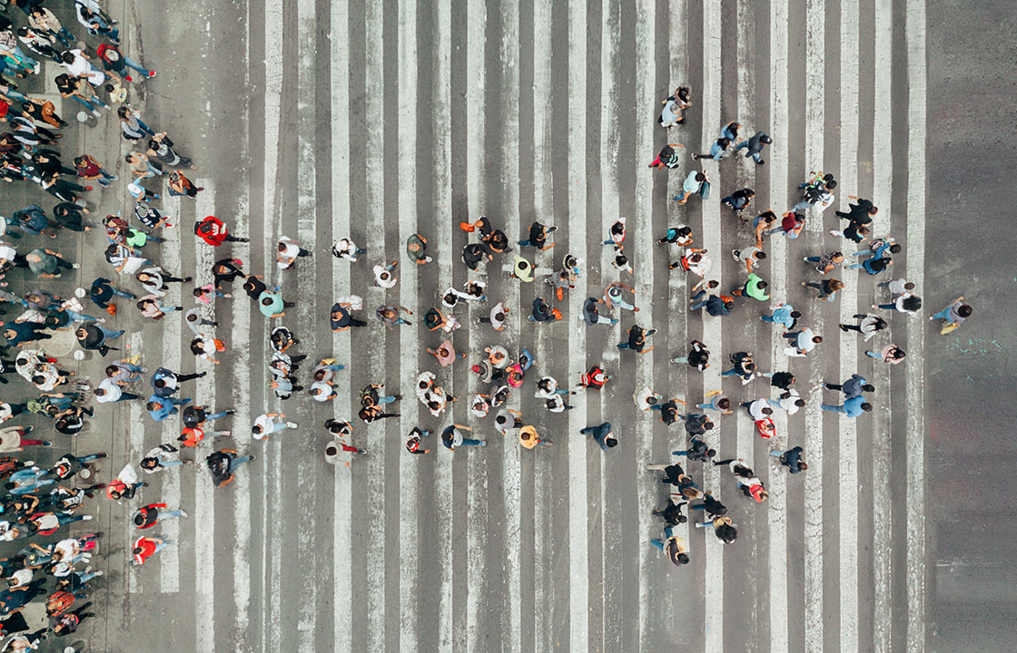 crowd of people walking in same direction in arrow shape