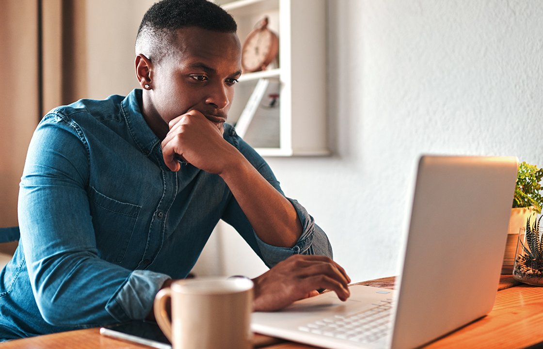 man in front of computer looking confused