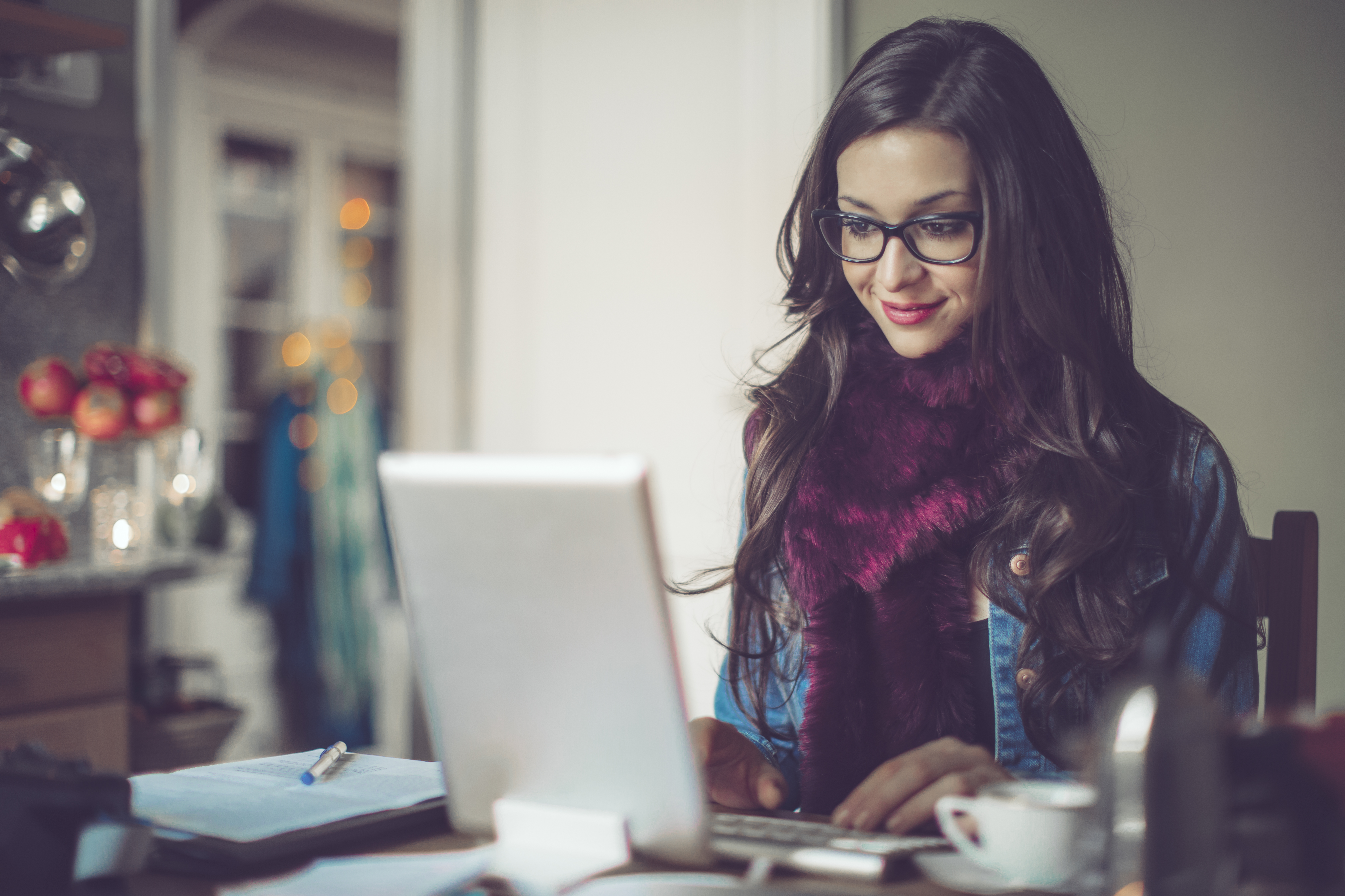 Smiling woman at home on laptop computer